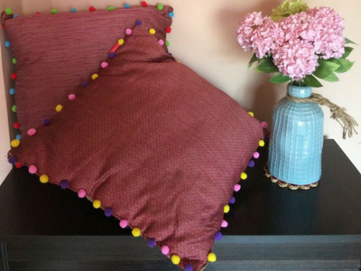 Get Cushiony with colourful pom poms